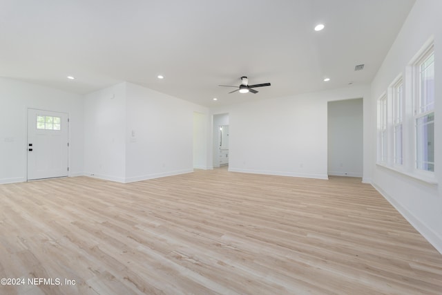 unfurnished living room featuring light wood-type flooring and ceiling fan