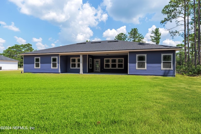 back of house with a lawn