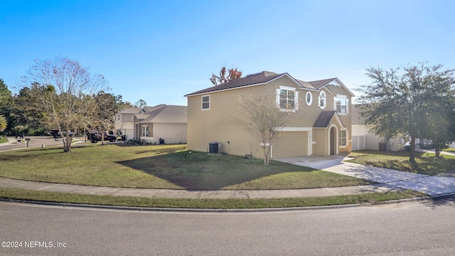 view of front facade featuring cooling unit, a front lawn, and a garage