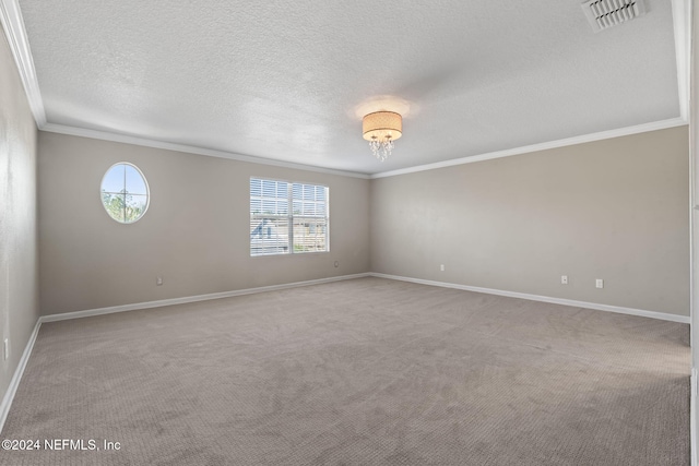 carpeted empty room with a textured ceiling, an inviting chandelier, and crown molding