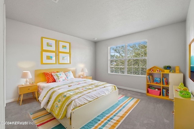 bedroom with carpet flooring and a textured ceiling