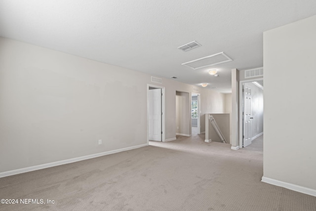 unfurnished room with light carpet