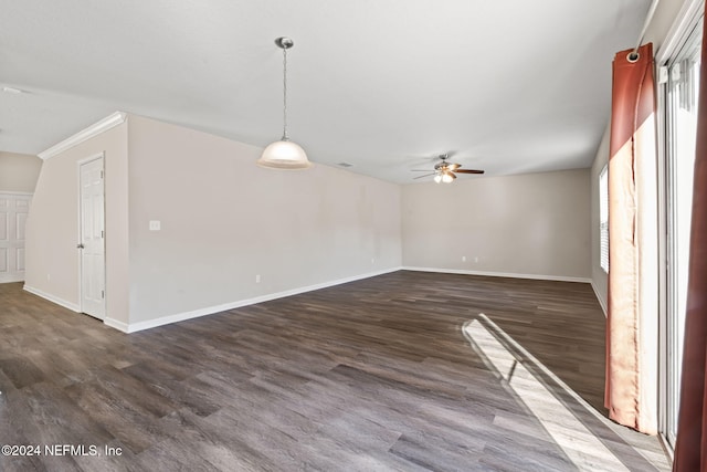 spare room with ceiling fan, crown molding, and dark hardwood / wood-style floors