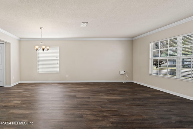 empty room with dark hardwood / wood-style flooring, a textured ceiling, and an inviting chandelier