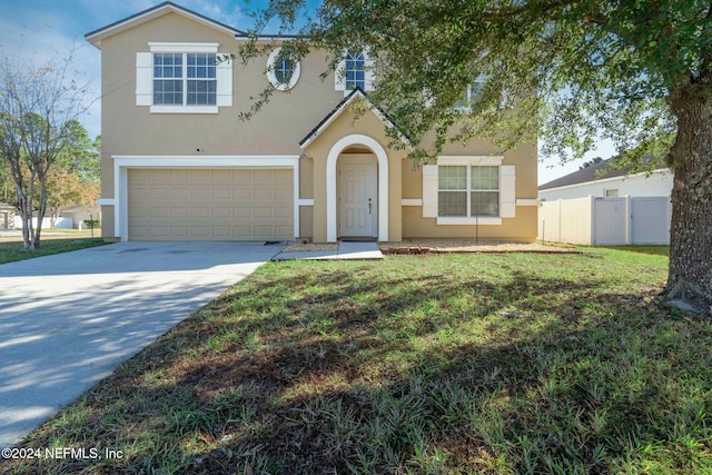 view of front facade featuring a front yard and a garage