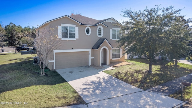 view of front property featuring a front lawn and a garage