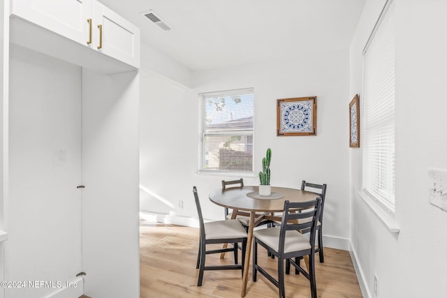 dining space with light hardwood / wood-style flooring