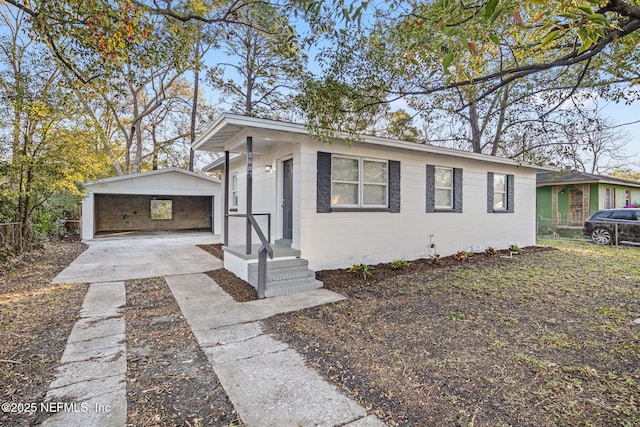 view of front of property with an outbuilding and fence