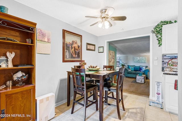 tiled dining area with ceiling fan