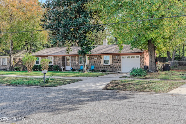 ranch-style home featuring a front yard and a garage