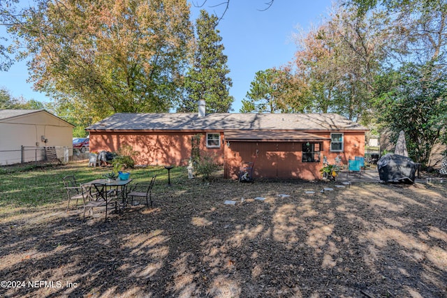 rear view of property with a lawn