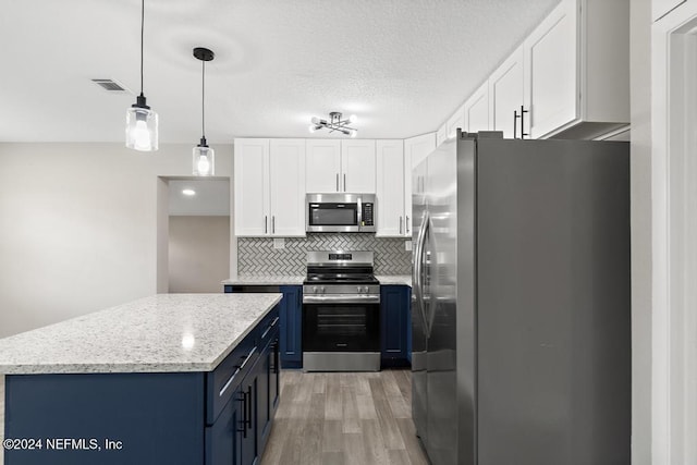 kitchen featuring white cabinetry, stainless steel appliances, blue cabinets, light hardwood / wood-style floors, and decorative light fixtures