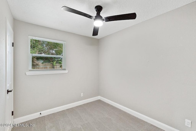 unfurnished room featuring light carpet and ceiling fan