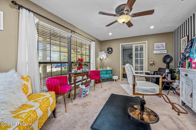 interior space featuring light carpet and ceiling fan