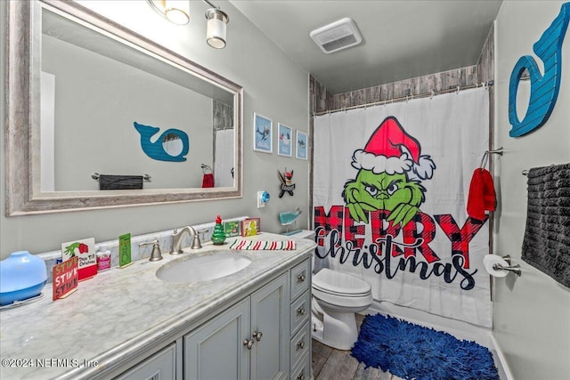 bathroom with vanity, hardwood / wood-style flooring, toilet, and walk in shower