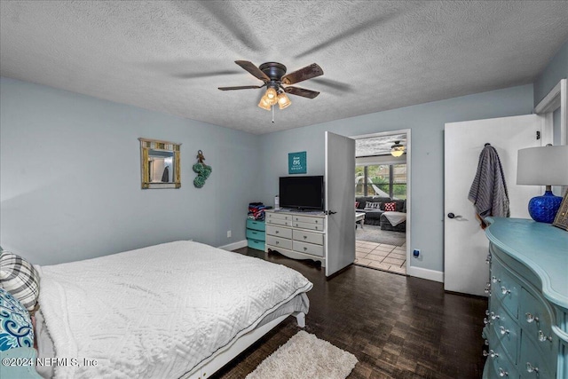 bedroom with dark hardwood / wood-style floors, ceiling fan, and a textured ceiling