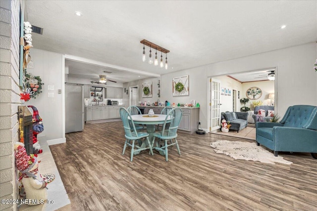 dining area with hardwood / wood-style flooring and a textured ceiling