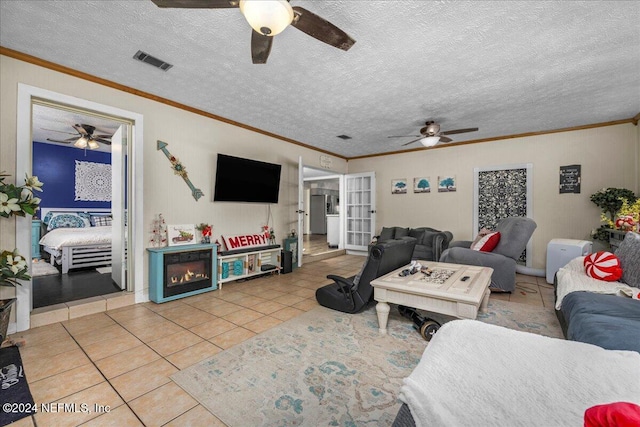 tiled living room with a textured ceiling and crown molding