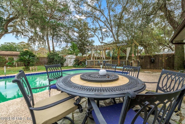 view of patio / terrace featuring a fenced in pool and a storage shed