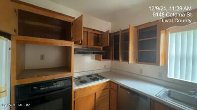 kitchen with black oven, white gas stovetop, dishwasher, and sink