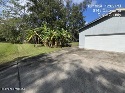 view of home's exterior featuring a garage and a lawn