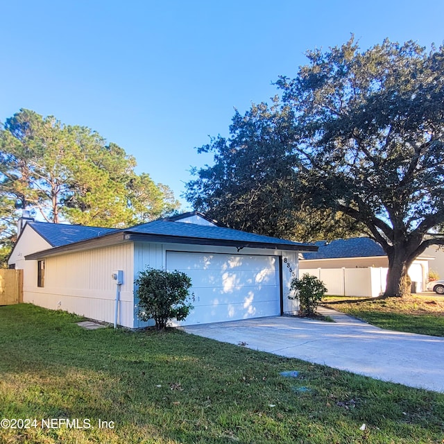 view of property exterior with a garage and a yard