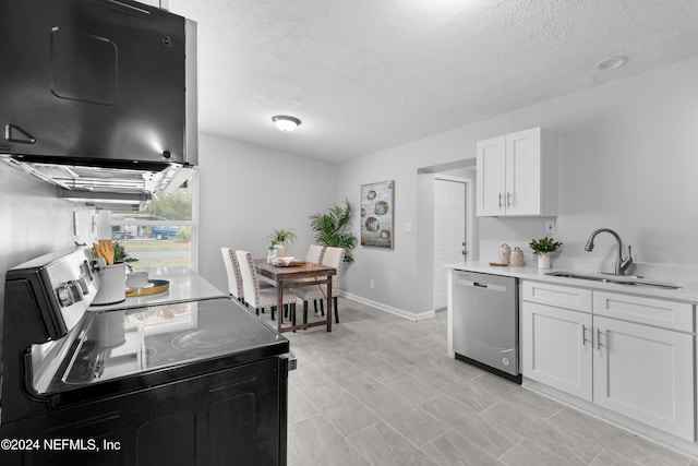 kitchen with sink, white cabinets, a textured ceiling, and appliances with stainless steel finishes