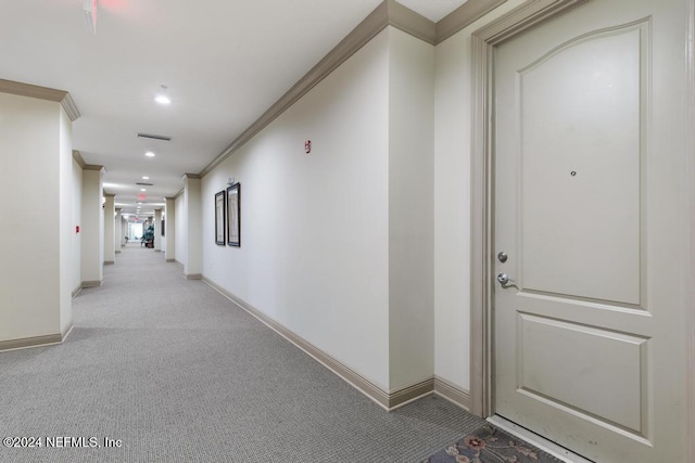 hall featuring light carpet and crown molding