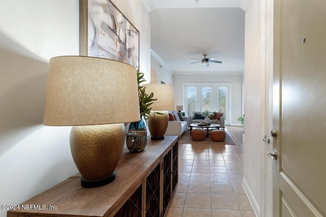 hall featuring ornamental molding and light tile patterned flooring