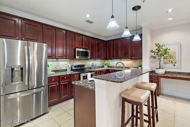 kitchen with appliances with stainless steel finishes, tasteful backsplash, dark stone counters, a breakfast bar, and crown molding