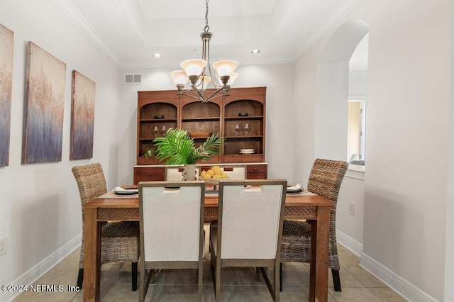 dining room featuring tile patterned flooring, an inviting chandelier, and crown molding