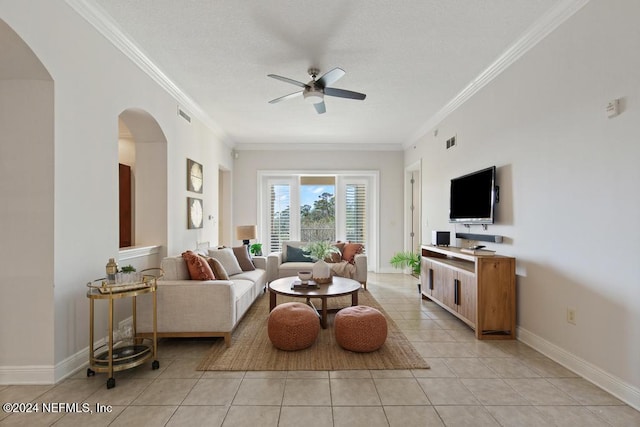 tiled living room featuring ceiling fan and ornamental molding