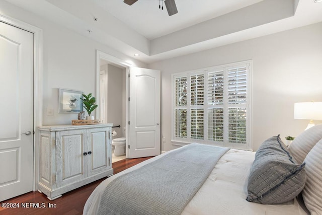 bedroom with ceiling fan, dark hardwood / wood-style floors, and ensuite bathroom