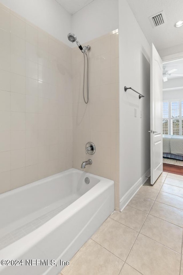 bathroom featuring tiled shower / bath combo and tile patterned floors