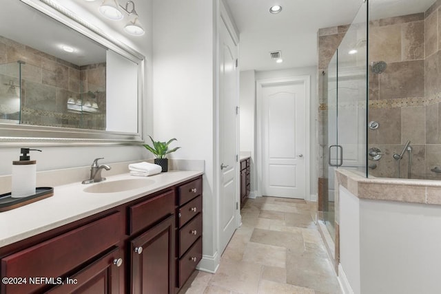 bathroom with vanity and a shower with shower door