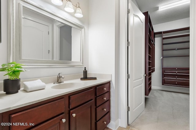 bathroom featuring vanity and a textured ceiling