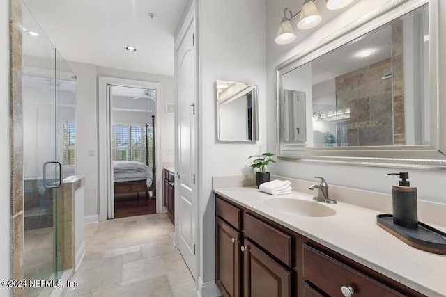 bathroom with ceiling fan, vanity, and a shower with shower door