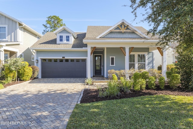 view of front facade featuring a front yard and a garage