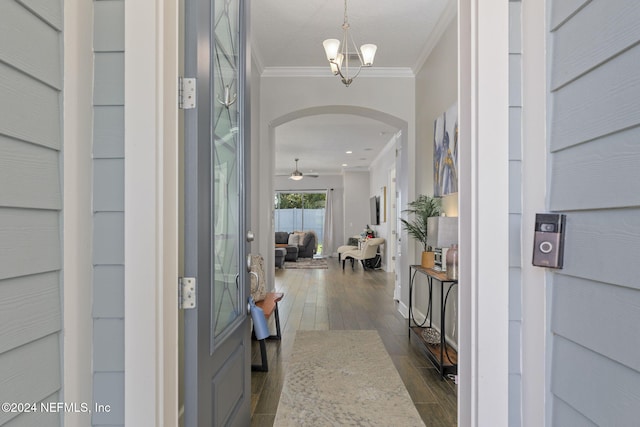 entryway with crown molding, ceiling fan with notable chandelier, and dark hardwood / wood-style floors