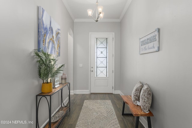 entrance foyer with dark wood-type flooring, crown molding, and a notable chandelier