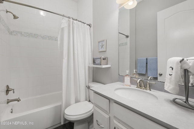 full bathroom featuring vanity, shower / bathtub combination with curtain, and toilet