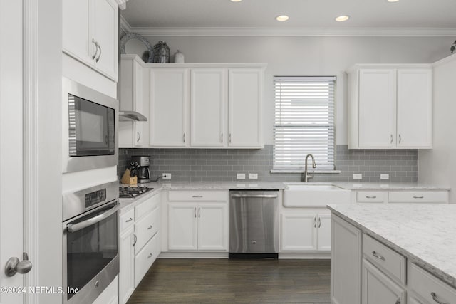 kitchen featuring dark hardwood / wood-style flooring, sink, white cabinets, and stainless steel appliances