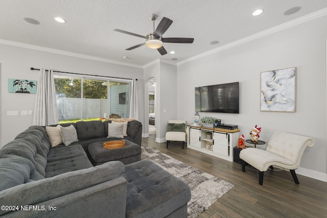 living room with a textured ceiling, dark hardwood / wood-style flooring, ceiling fan, and crown molding