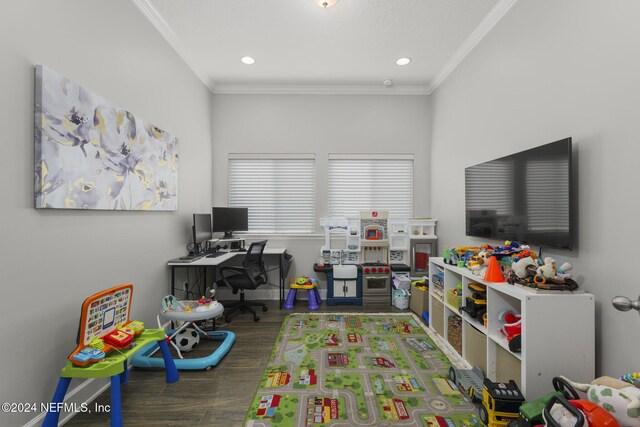 game room with dark hardwood / wood-style floors and ornamental molding