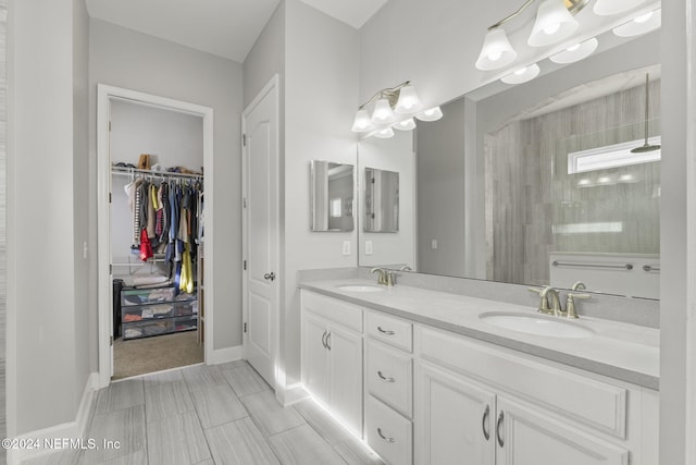 bathroom with vanity and a tile shower