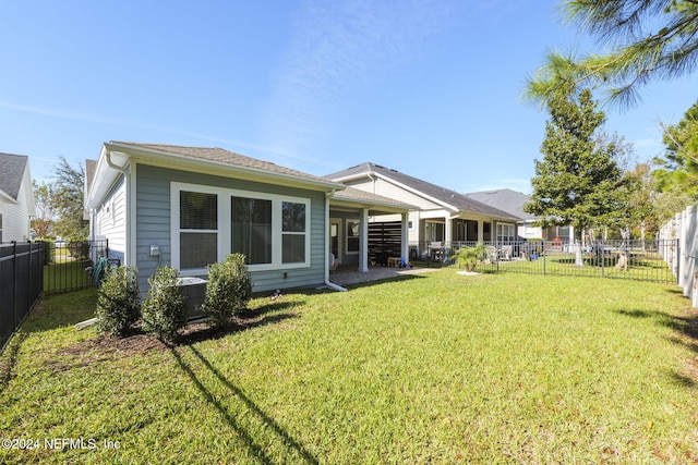 back of house featuring a lawn