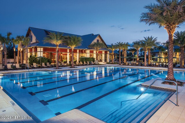 pool at dusk with a patio