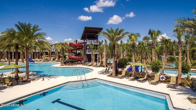 view of pool featuring a patio area and a water slide