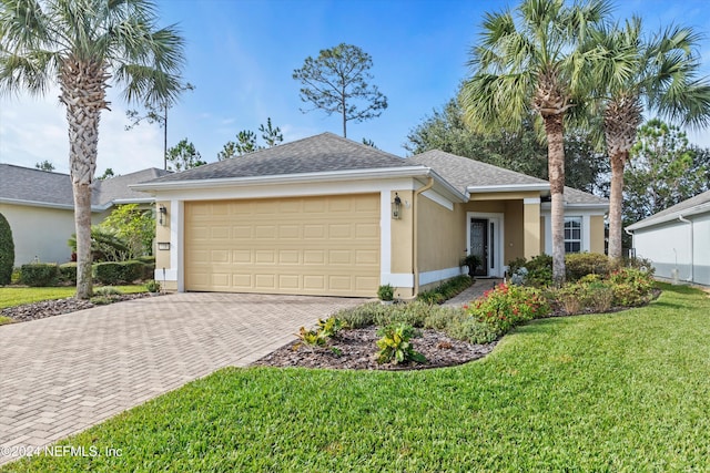 ranch-style home featuring a garage and a front lawn