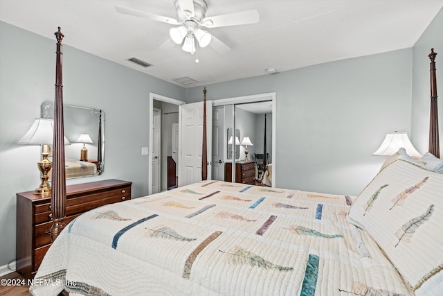 bedroom with ceiling fan, a closet, and wood-type flooring